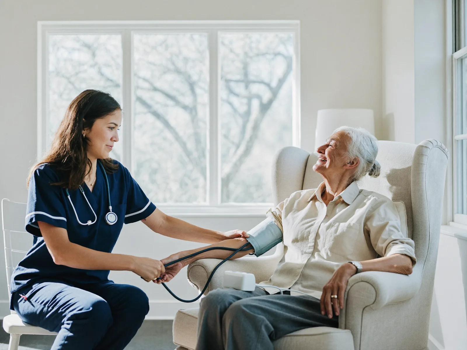 Blood pressure being taken for a senior at home